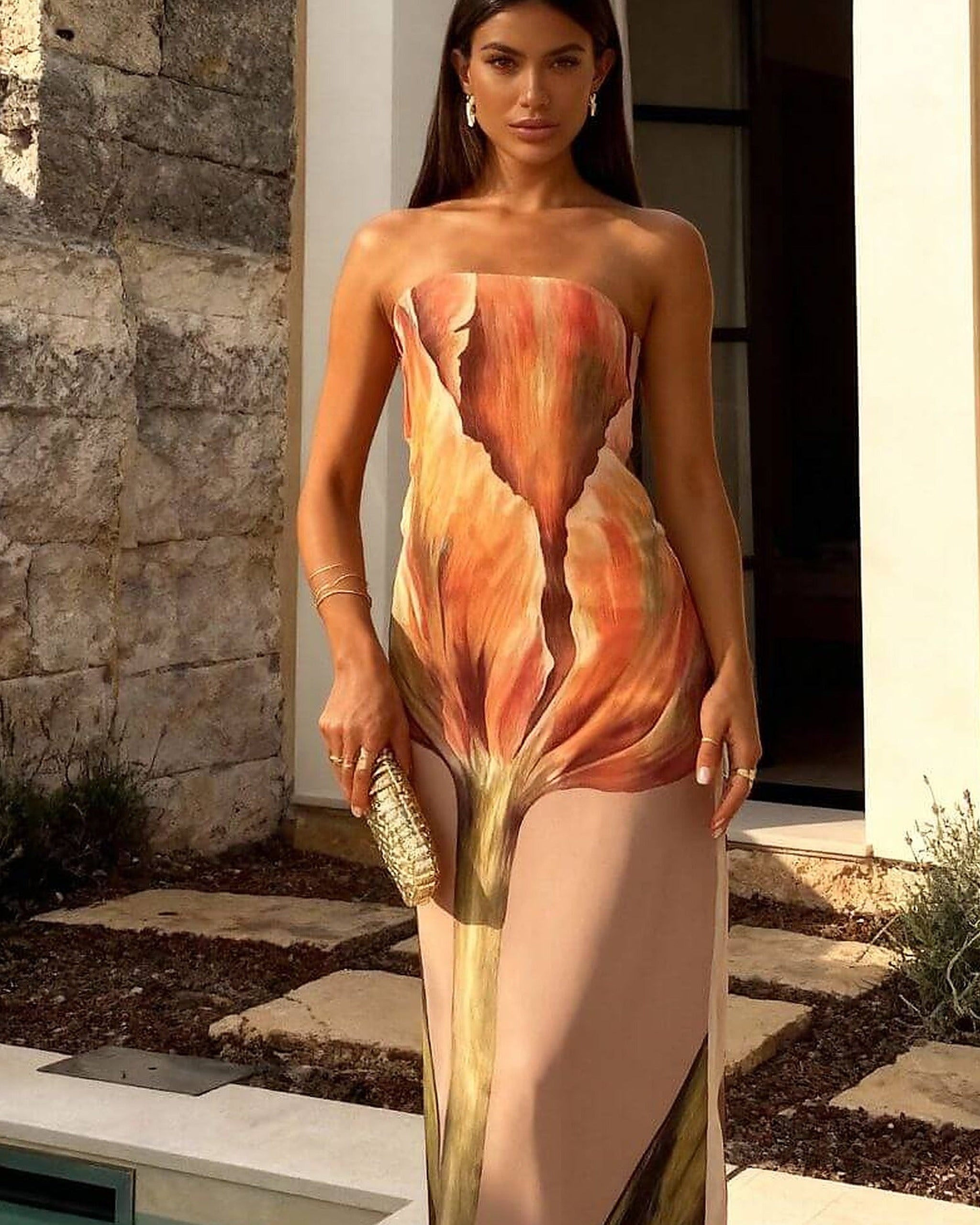 Brown and cream one-piece swimsuit with adjustable straps and elegant draping detail
