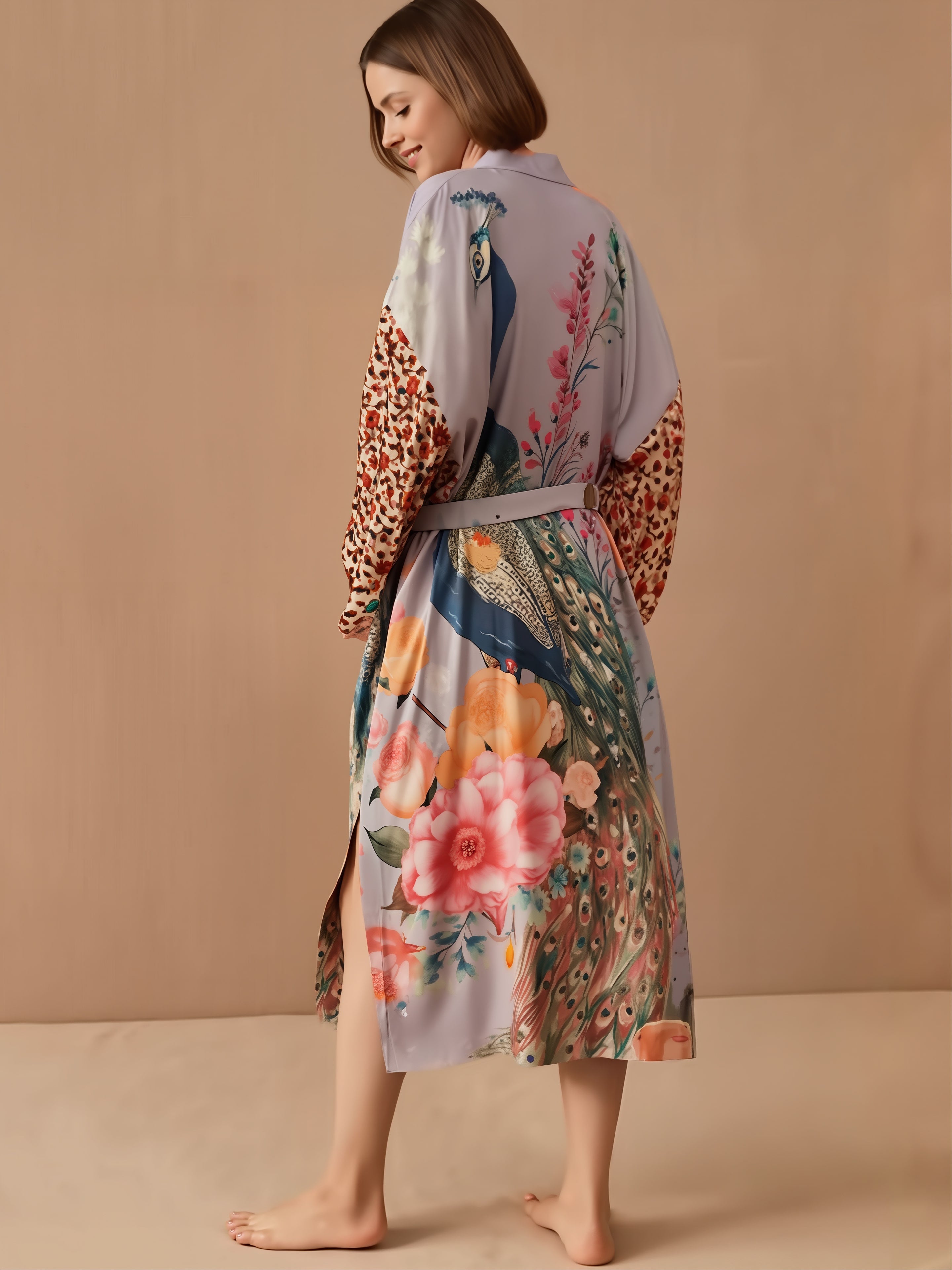 Woman wearing Blossom Flower bikini with matching cover-up robe featuring peacock and floral print design in soft pastels