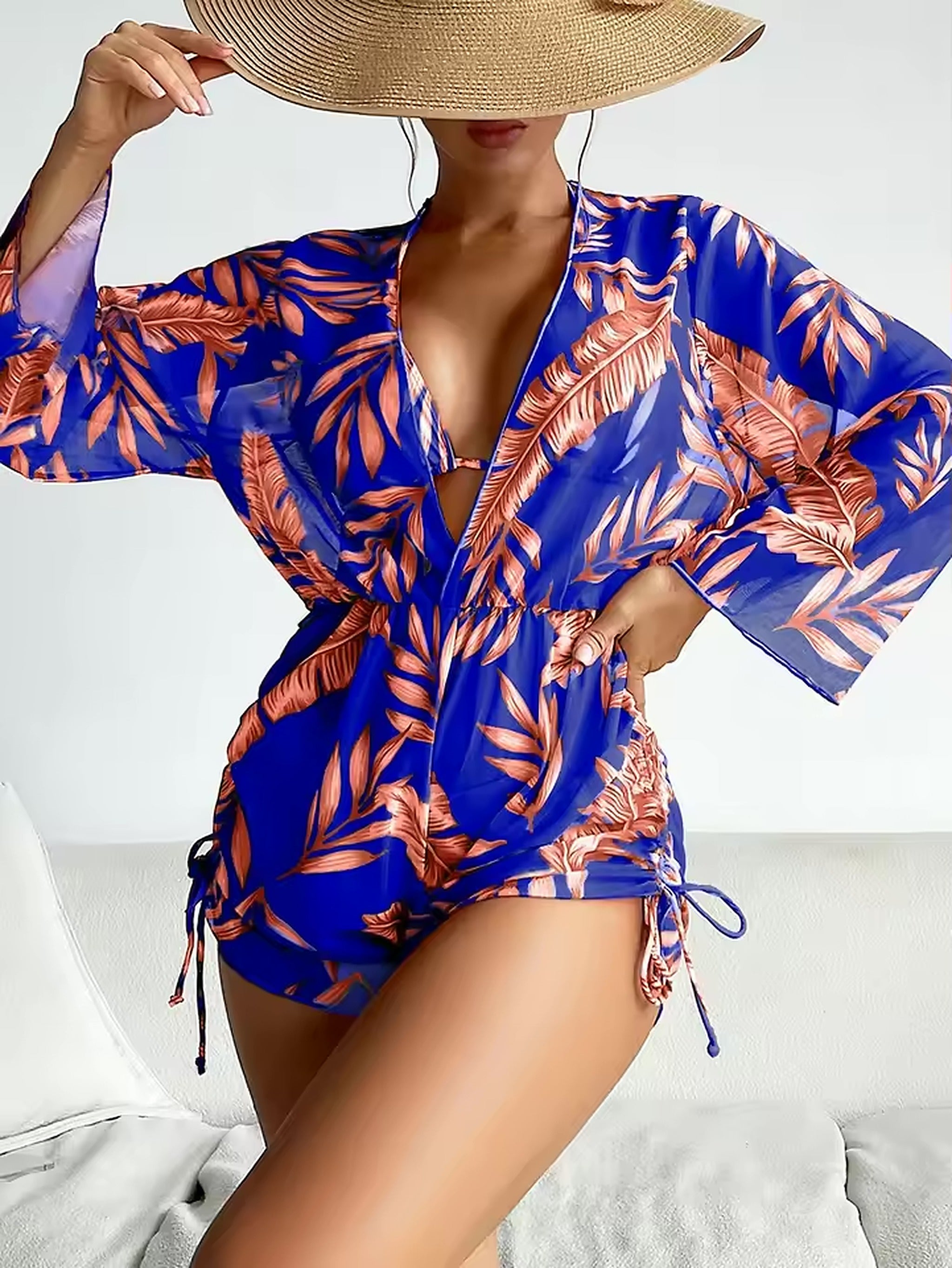 Blue and coral tropical leaf print bikini with matching wrap shirt and wide-brim straw hat