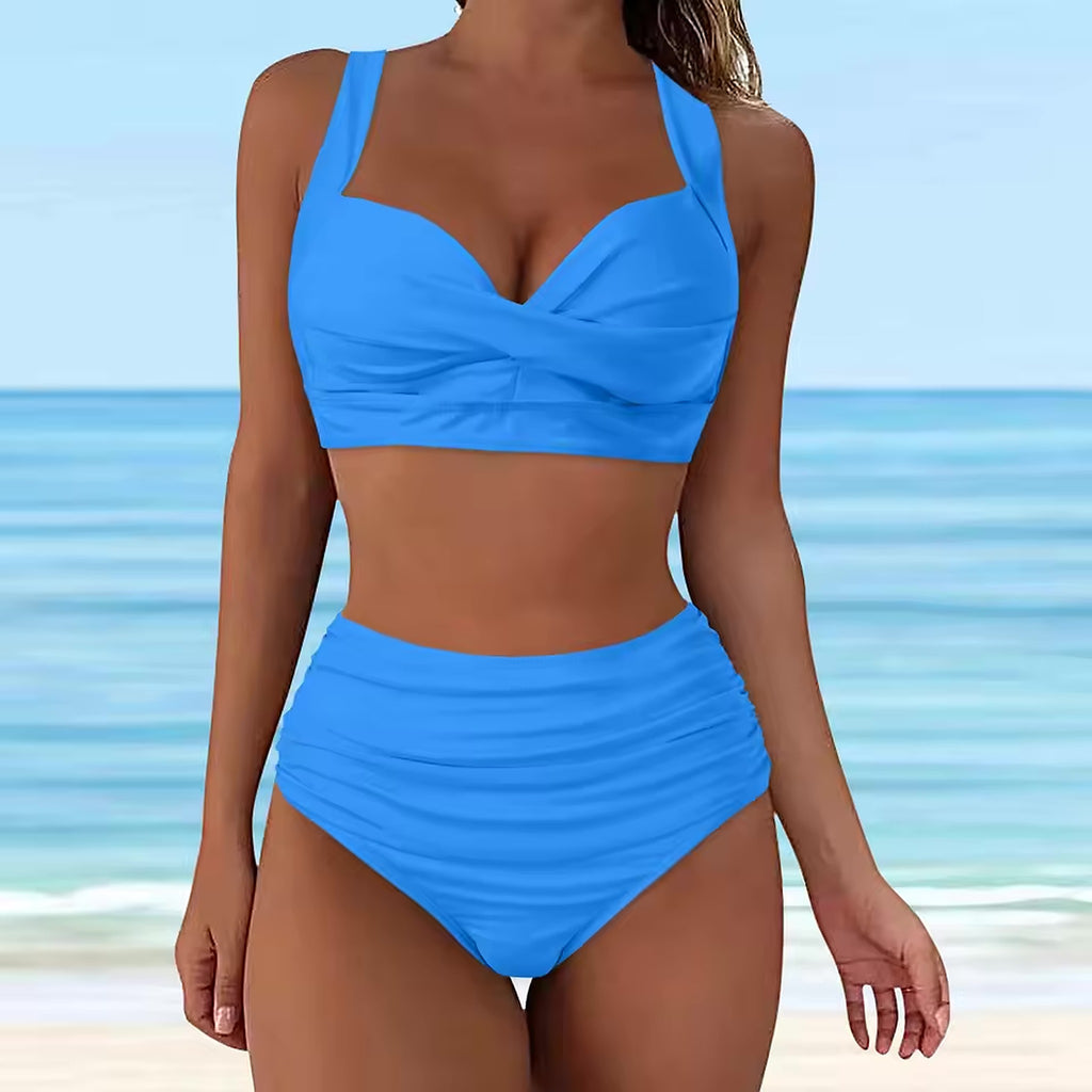 Bright blue bikini with twist front crop top and high-waisted ruched bottoms on beach background