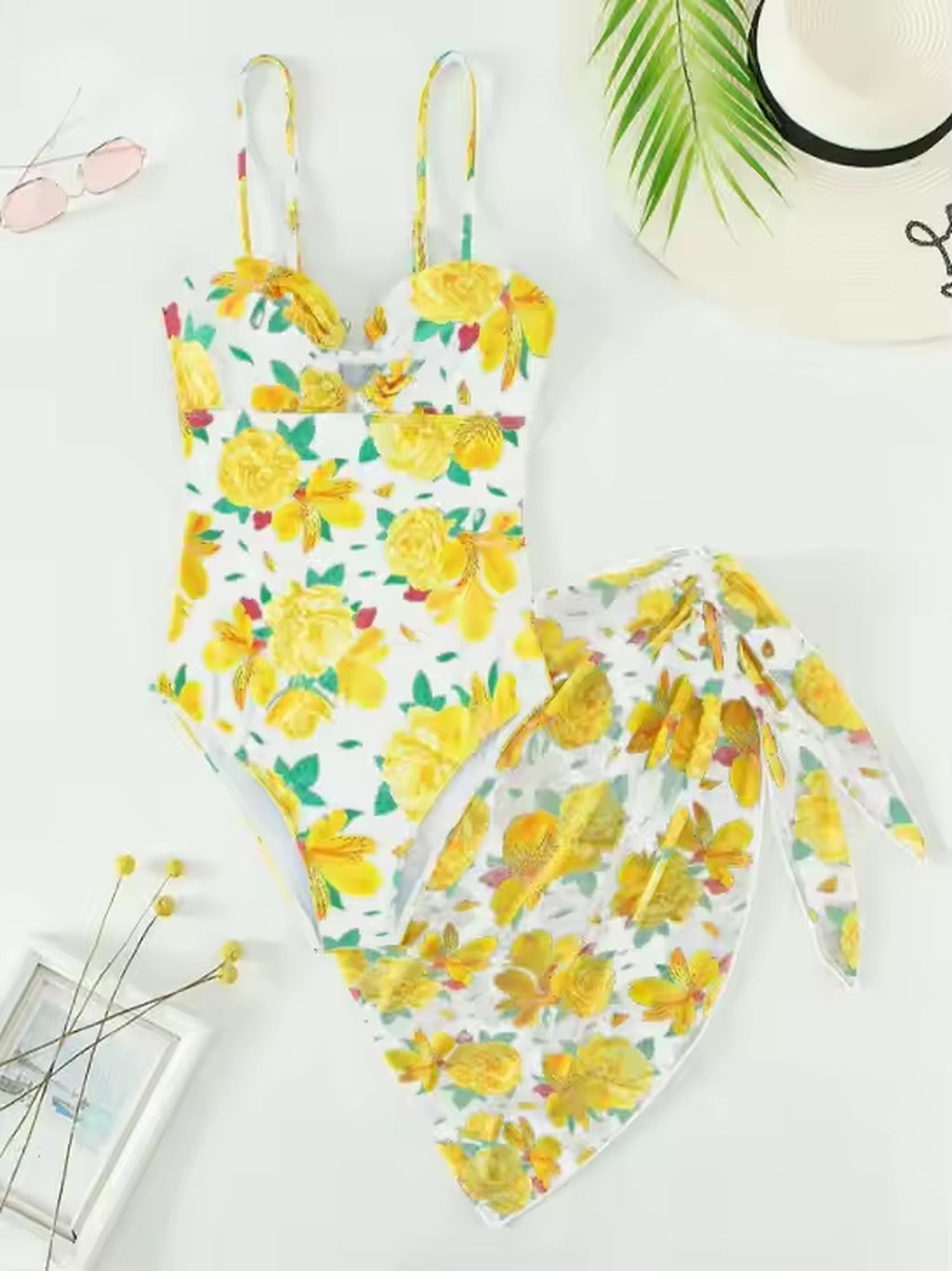 Yellow floral bikini set with matching sarong, featuring colorful blooms on white background
