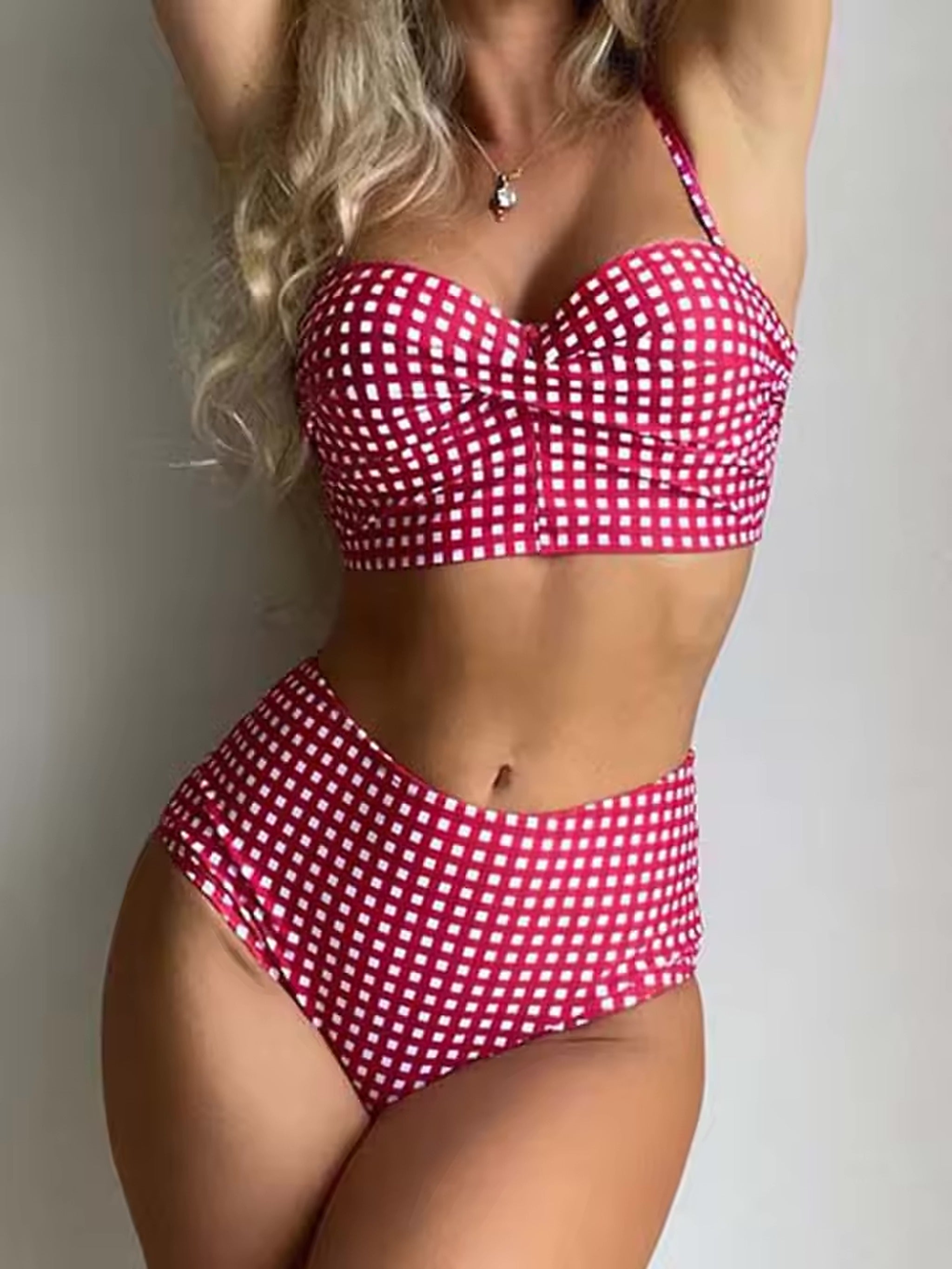 Woman wearing Luna bikini in burgundy and white checkered pattern with sweetheart neckline and high-waisted bottoms