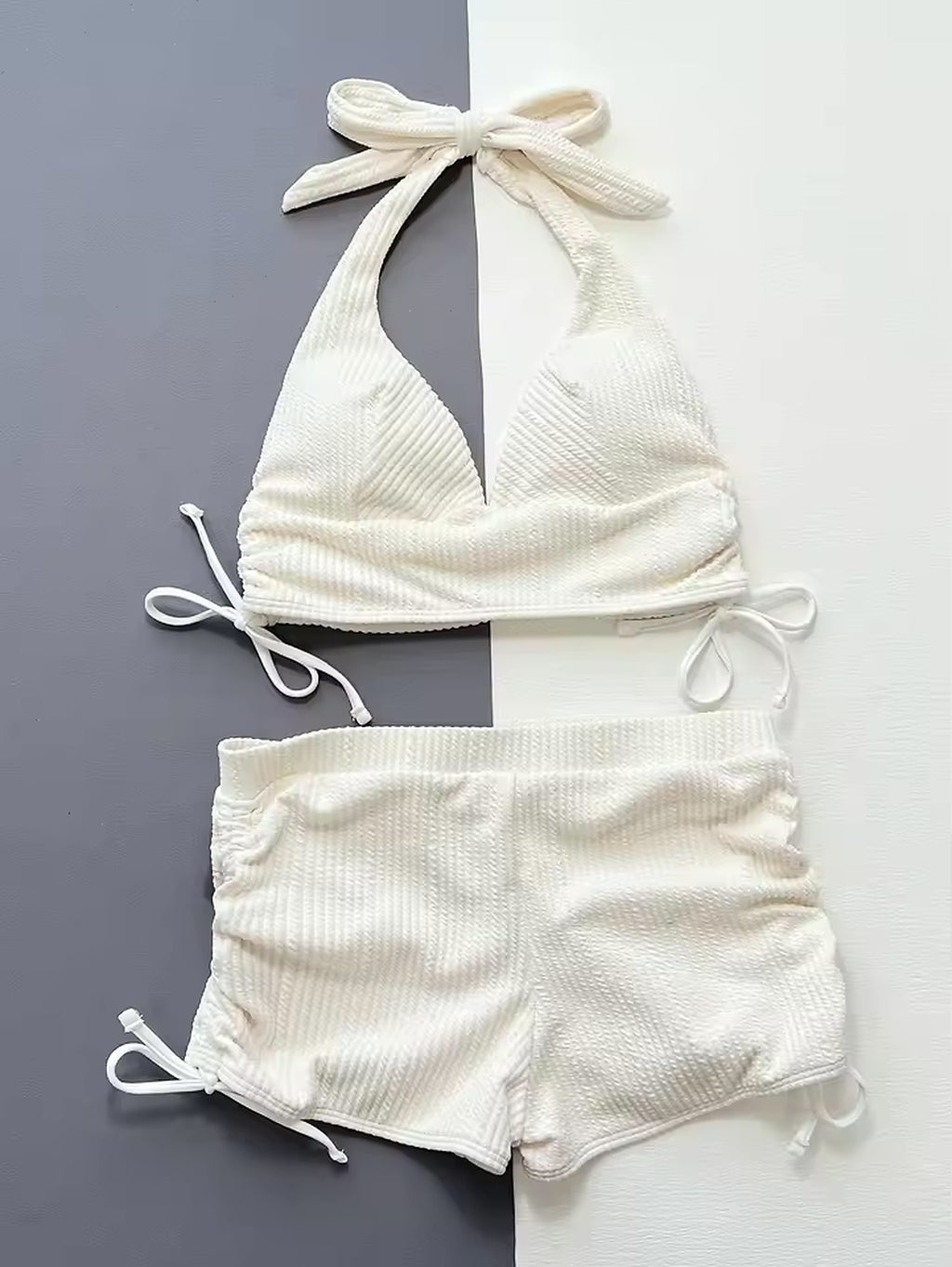 White ribbed halter bikini with tie-side bottoms and adjustable straps on neutral background
