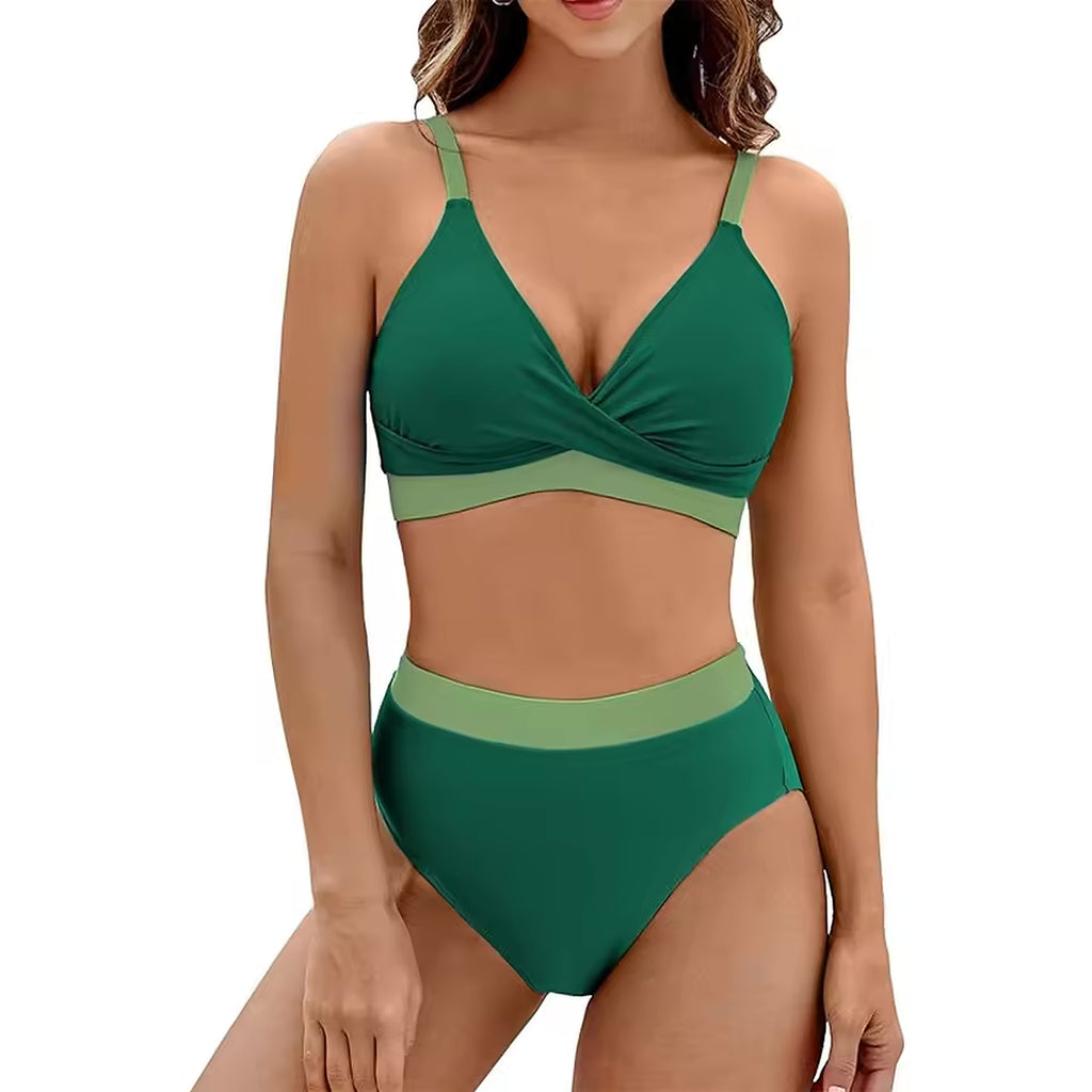 Woman wearing Moana Drift bikini in forest green with sage green trim, featuring wrap-style top and high-waisted bottoms